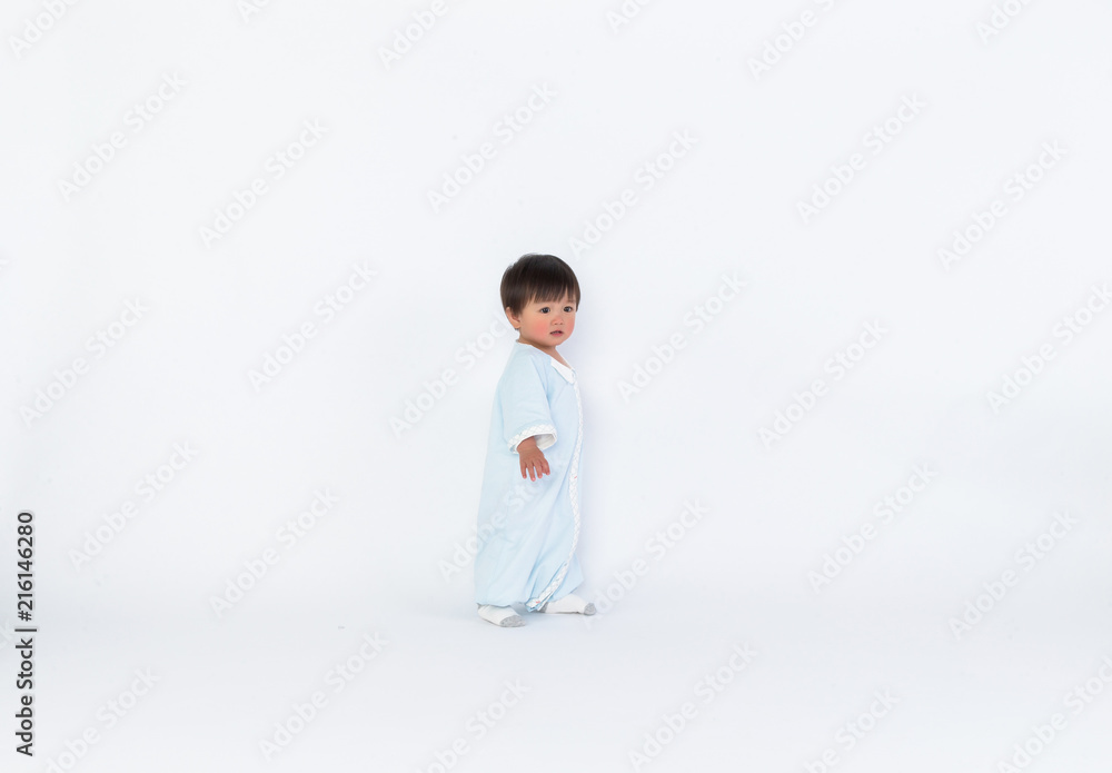 Infant child baby girl kid toddler in diaper make first steps isolated on a white background Infant child baby girl kid toddler in diaper make first steps isolated on a white background