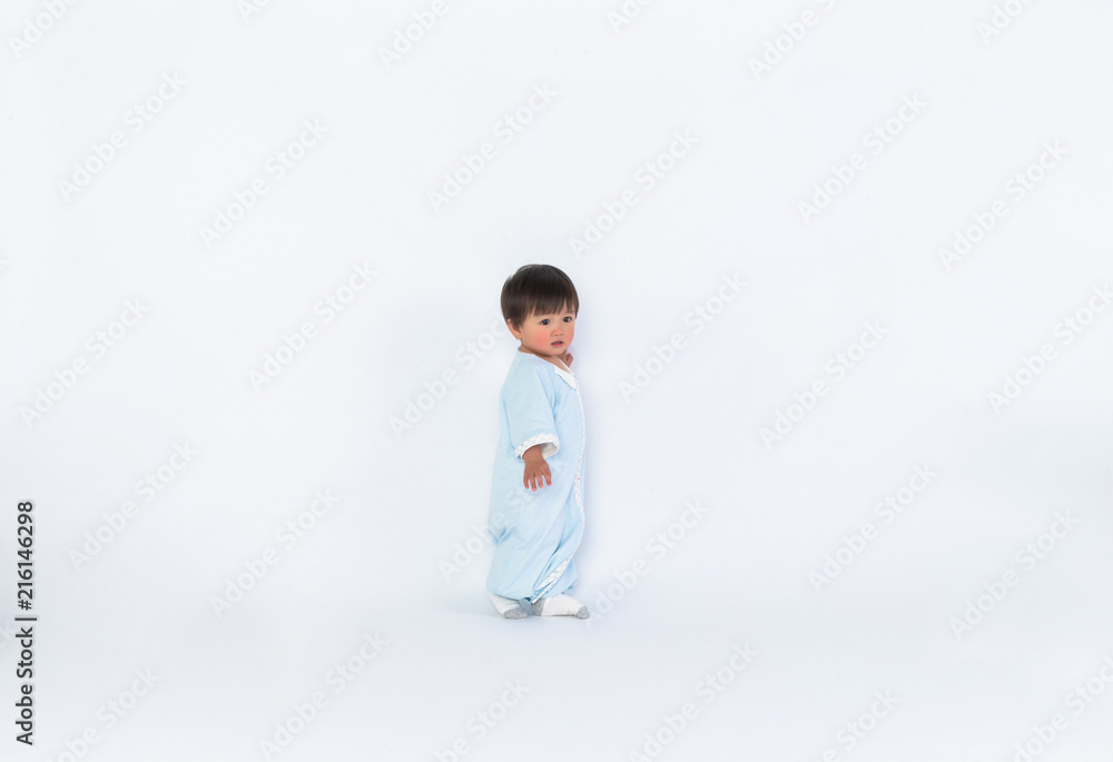 Infant child baby girl kid toddler in diaper make first steps isolated on a white background Infant child baby girl kid toddler in diaper make first steps isolated on a white background
