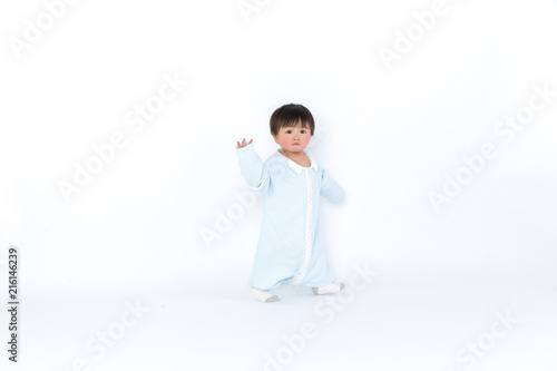 Infant child baby girl kid toddler in diaper make first steps isolated on a white background