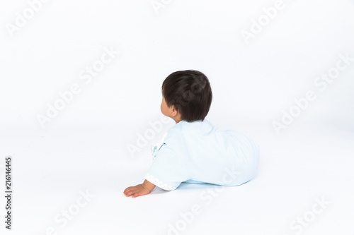 beautiful little baby sits on the floor isolated on white background
