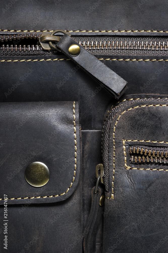 Leather bag with zipper, magnetic clasp on pocket and stitches, man accessories in vintage style, macro shot, selective focus Leather bag with zipper, magnetic clasp on pocket and stitches, man accessories in vintage style, macro shot, selective focus