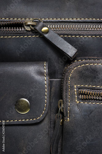Leather bag with zipper, magnetic clasp on pocket and stitches, man accessories in vintage style, macro shot, selective focus  © antonmatveev
