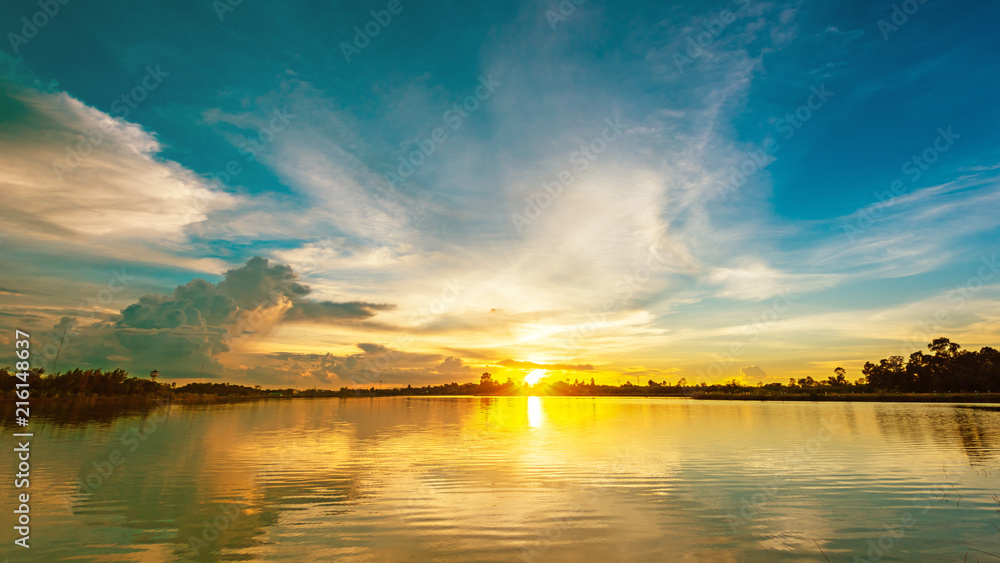 Scenery sunset over calm lake landscape panorama, Beautiful sunlight and sunset reflection