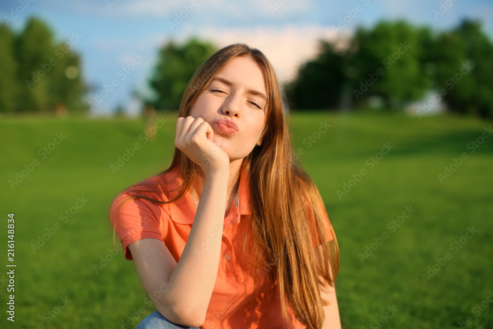 Happy young woman resting in park on sunny day Happy young woman resting in park on sunny day