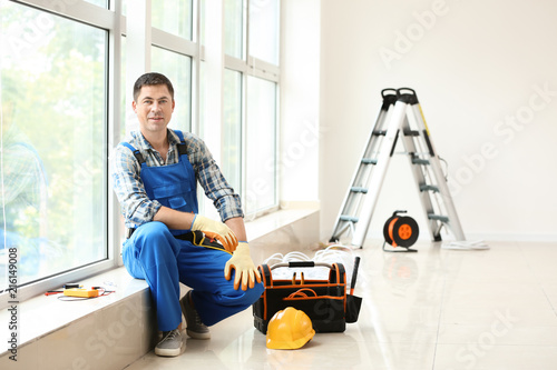 Electrician with toolbox si...