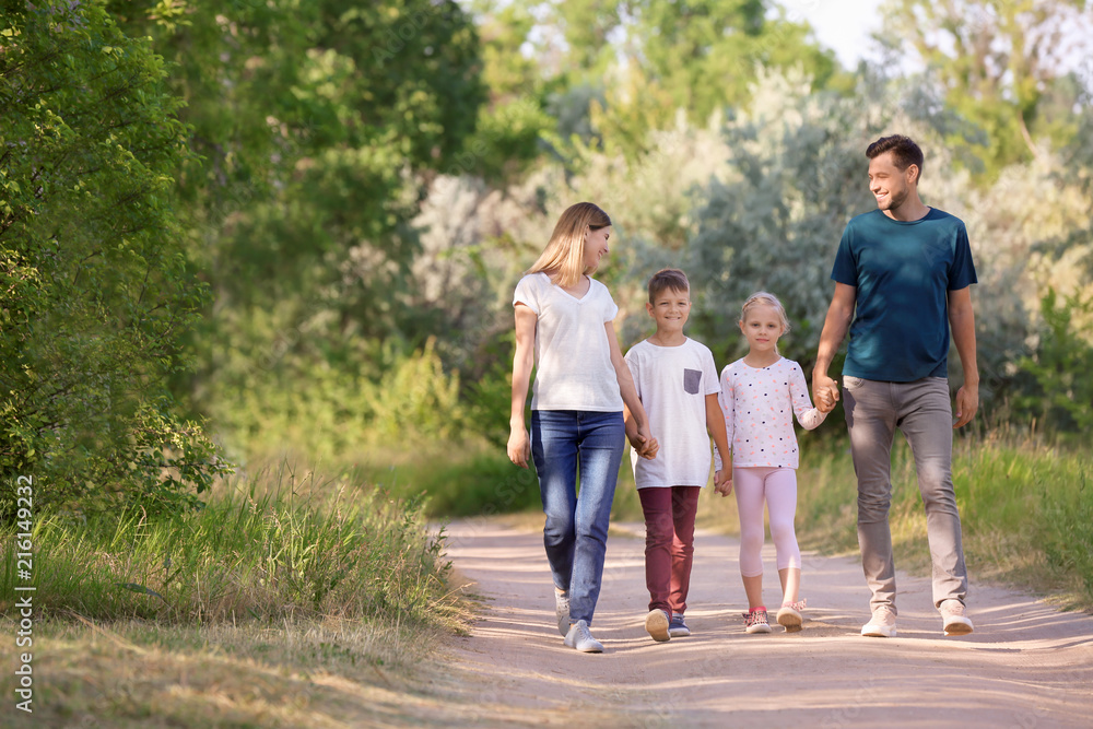 Family walking in park on summer day