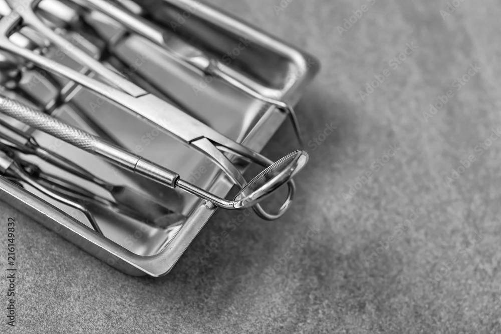 Tray with dentist's tools on grey table Tray with dentist's tools on grey table