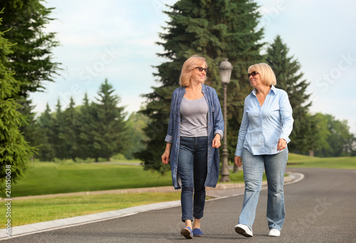 Mature women walking in par...