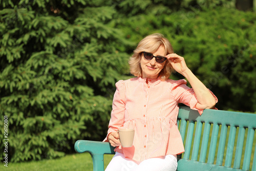 Beautiful mature woman drin...