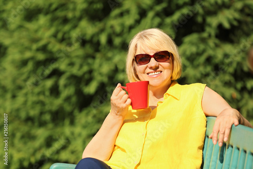 Beautiful mature woman drin...