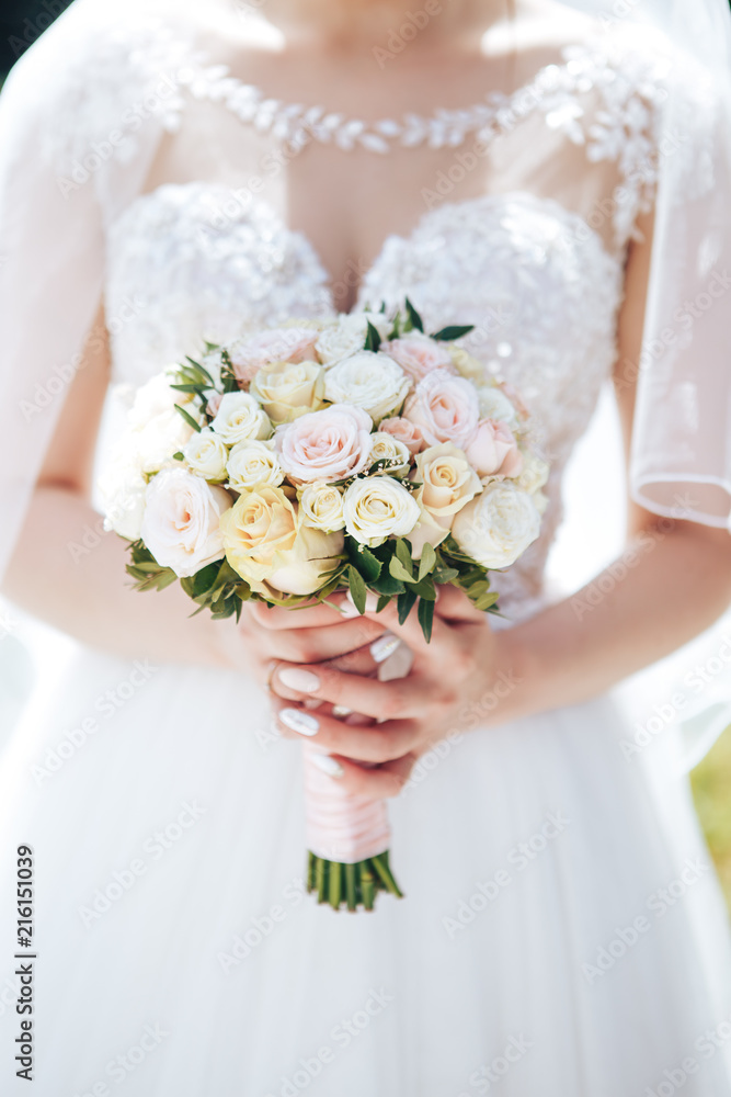 The bride is holding a wedding bouquet. Close-up The bride is holding a wedding bouquet. Close-up