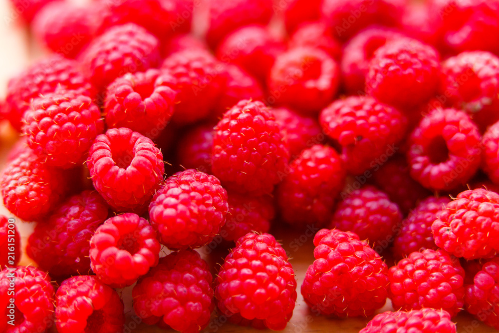 Raspberries on wooden board macro. Ripe raspberries Raspberries on wooden board macro. Ripe raspberries