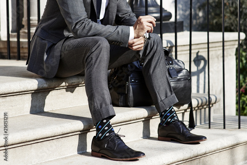 Man in suit sitting on stairs photo