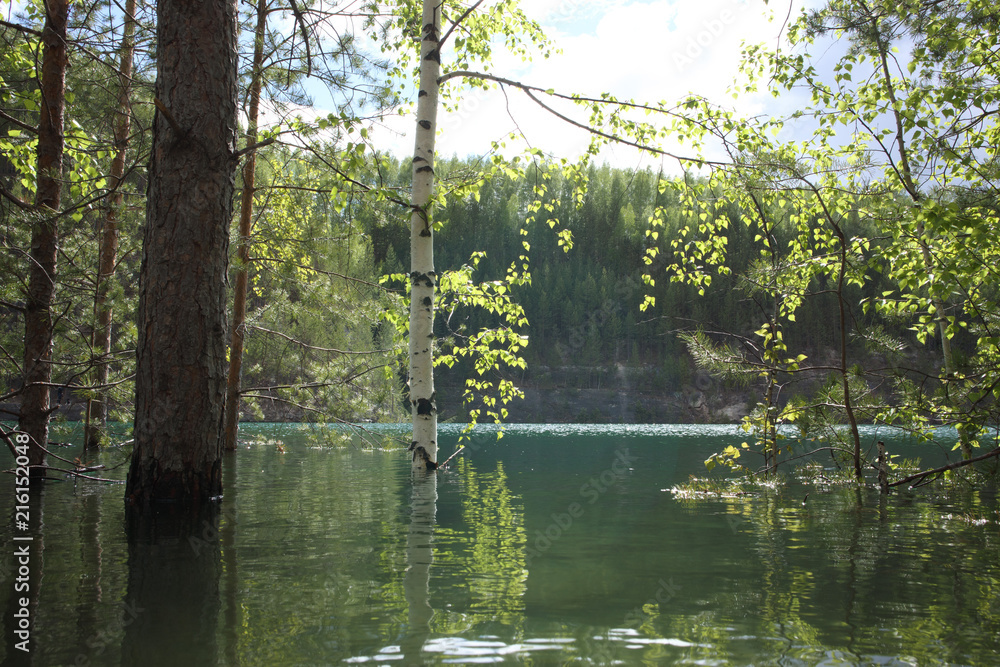 Flooded quarry with blue water Flooded quarry with blue water