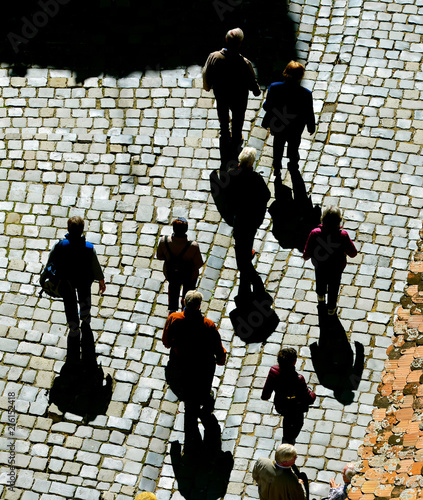people walking by cobblesto...