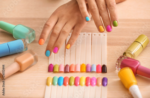 Young woman with colorful manicure in beauty salon