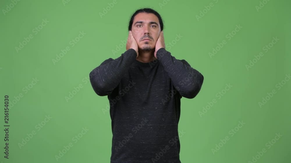 Handsome man covering ears as three wise monkeys concept Handsome man covering ears as three wise monkeys concept