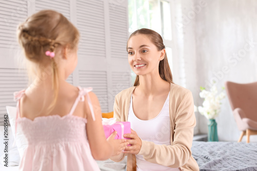 Cute little girl giving her...