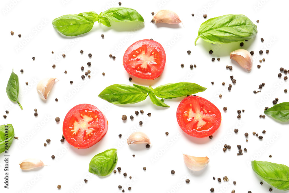 Fresh sliced tomatoes with basil and spices on white background Fresh sliced tomatoes with basil and spices on white background
