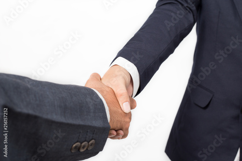 Closeup of two business handshake isolated on white background