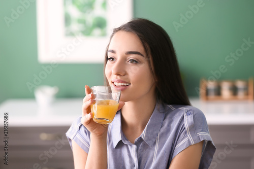 Young woman with glass of f...