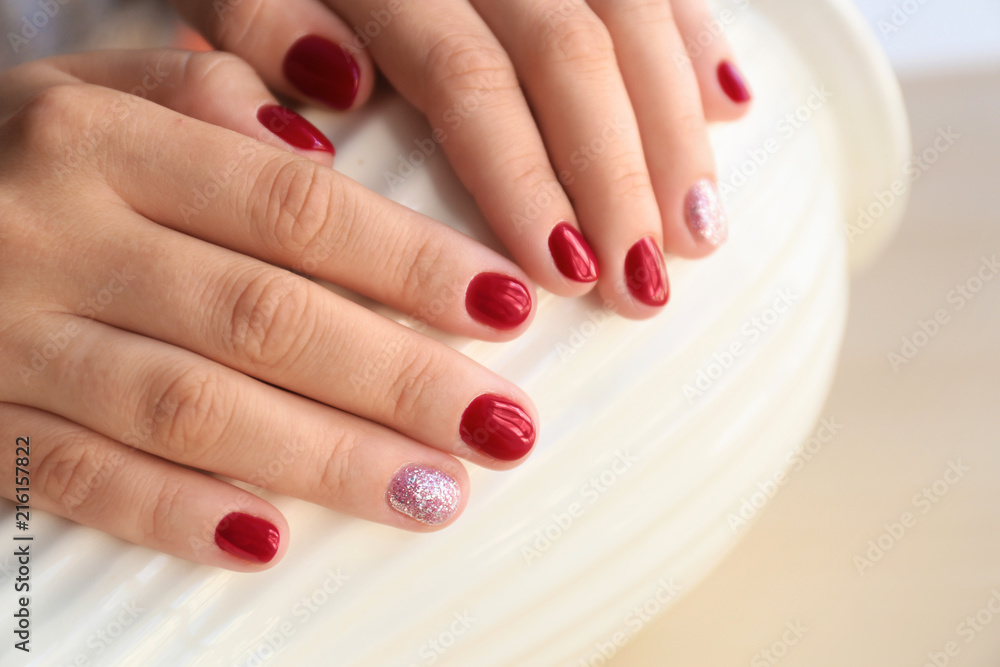 Woman with stylish color nails holding vase, closeup Woman with stylish color nails holding vase, closeup