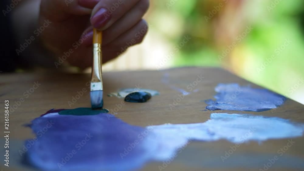 SLOW MOTION video of female artist mixing paint on palette SLOW MOTION video of female artist mixing paint on palette