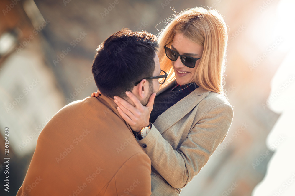 Happy couple smiling and hugging outdoor