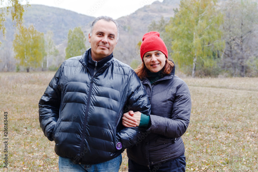 man and woman in autumn jackets outdoors