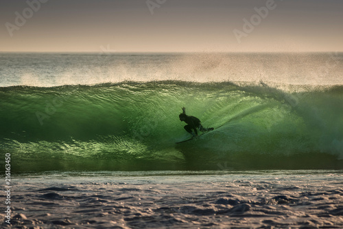 Surfer surfing on barreling wave, Crab Island, Doolin, Clare, Ireland photo