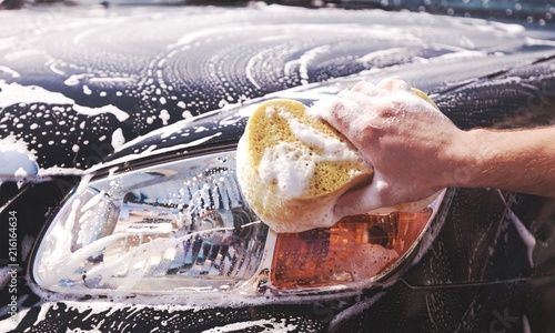 Man washing a soapy car photo