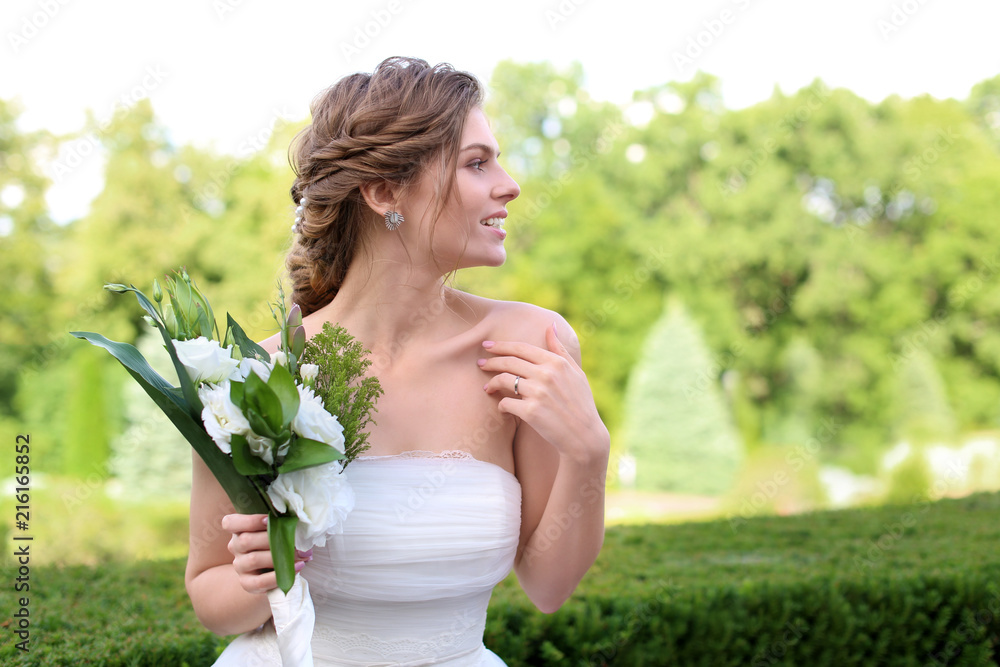 Beautiful young bride with wedding bouquet outdoors Beautiful young bride with wedding bouquet outdoors
