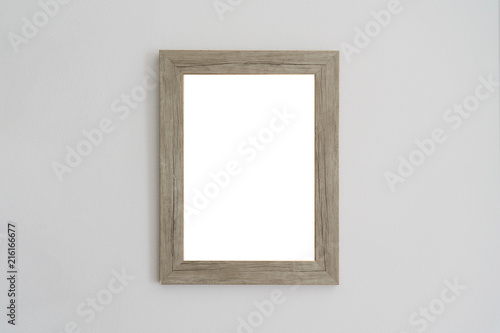 isolated blank wooden picture frame on the wall