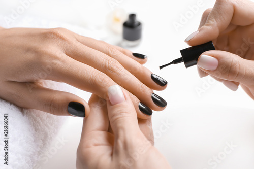 Young woman getting professional manicure in beauty salon  closeup