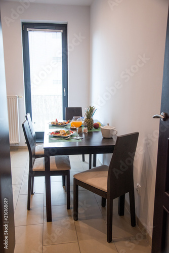 Healthy breakfast in kitchen. breakfast on table with omelet  sweet toasts  fruits and juice