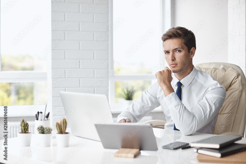 Young handsome businessman working in a modern office Young handsome businessman working in a modern office