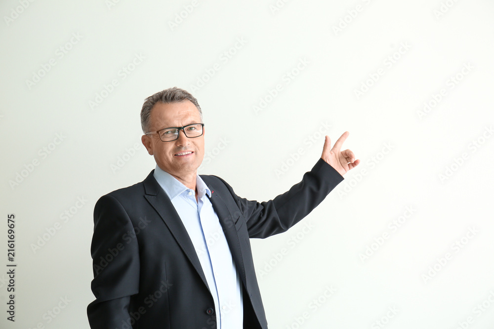 Mature businessman pointing at something on white background Mature businessman pointing at something on white background