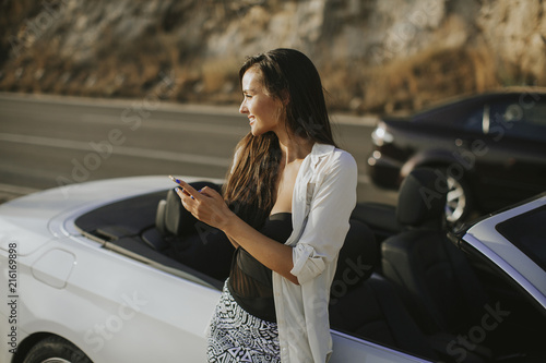 Young woman using mobile ph...