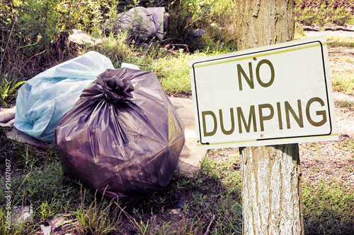 Photography Illegal dumping in the nature with No Dumping sign indicating in the countrysi