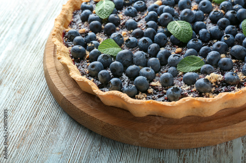 Delicious blueberry pie on wooden table, closeup
