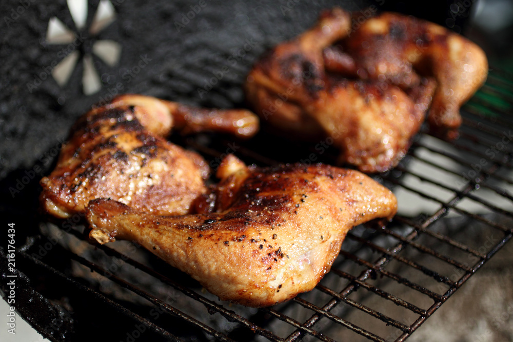 Grilled quarter chicken thighs and legs on the BBQ.