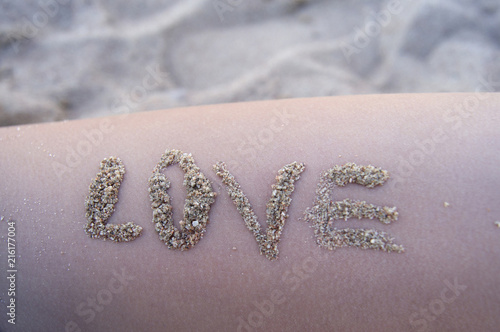 Summer mood, Sunny beach, words Of love sand on the skin.