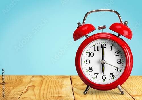 Blue Retro alarm clock on wooden table
