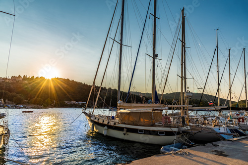 Beautiful sunset over Lefkada island in Greece. Sail boat on the harbor of Vasiliki port,