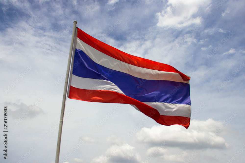 The Thai flag has a sky background with clouds in the sun at noon.