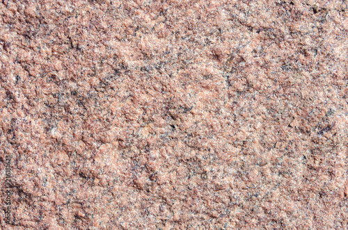 Facing material rose granite texture. Natural stone rose granite untreated background texture.