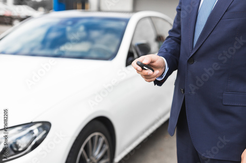 Male holding car keys with car on background © xartproduction
