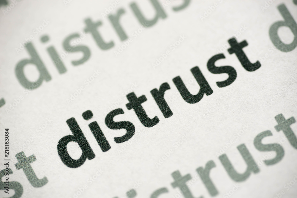 word distrust printed on paper macro