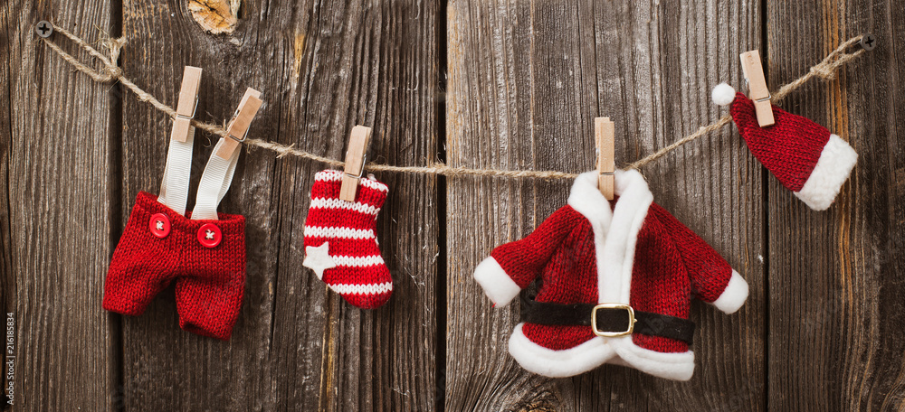Christmas decoration over wooden background Santa Claus clothes and jewelry  on the clothesline New Year banner internet Stock Photo | Adobe Stock