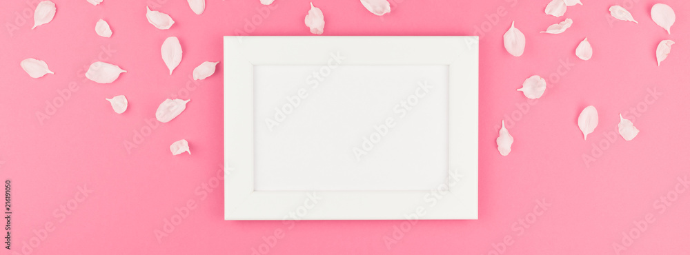 Flat lay of white frame mock up with petals